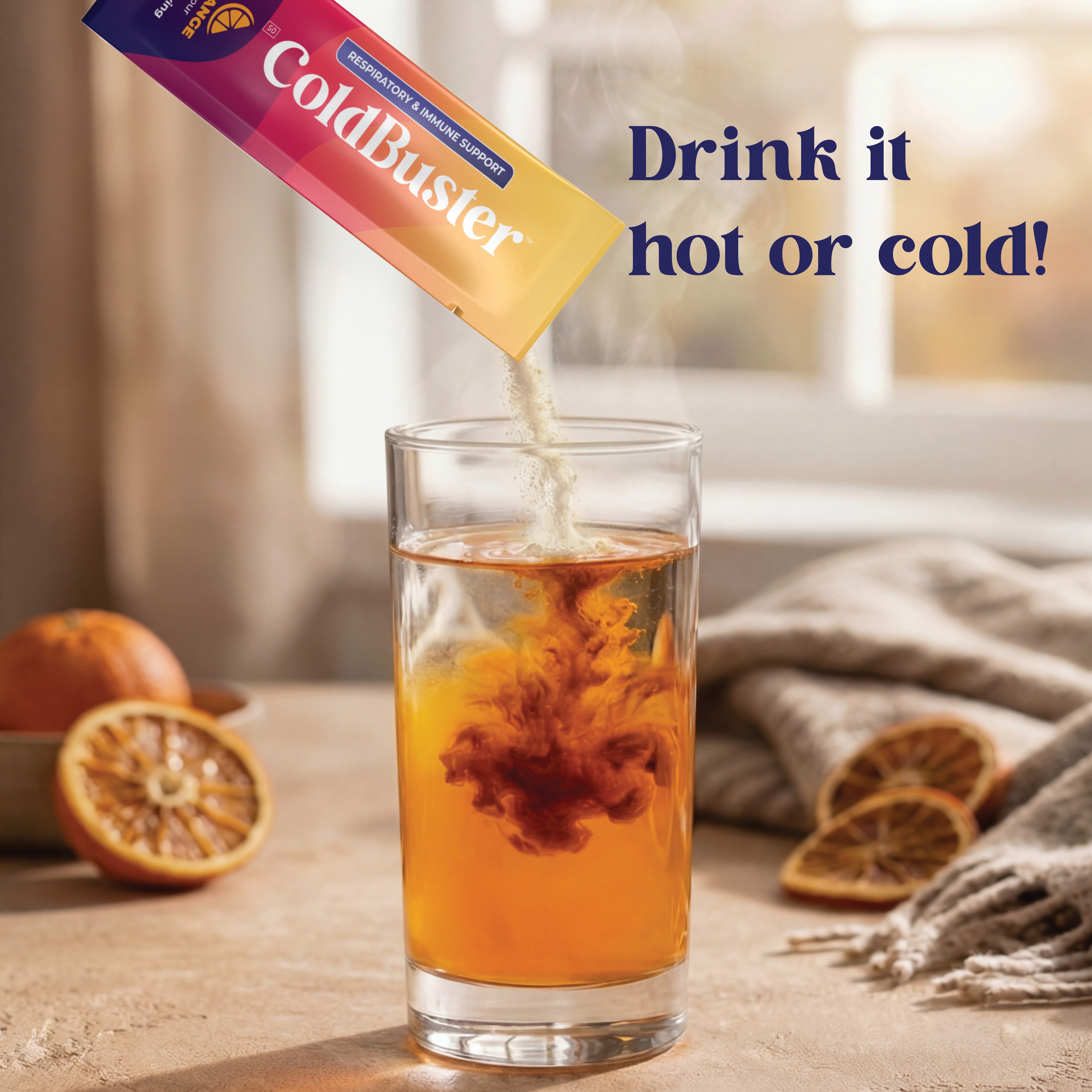 ColdBuster respiratory and immune support sachet pouring into a warm amber drink, showing the supplement can be mixed and consumed hot or cold.