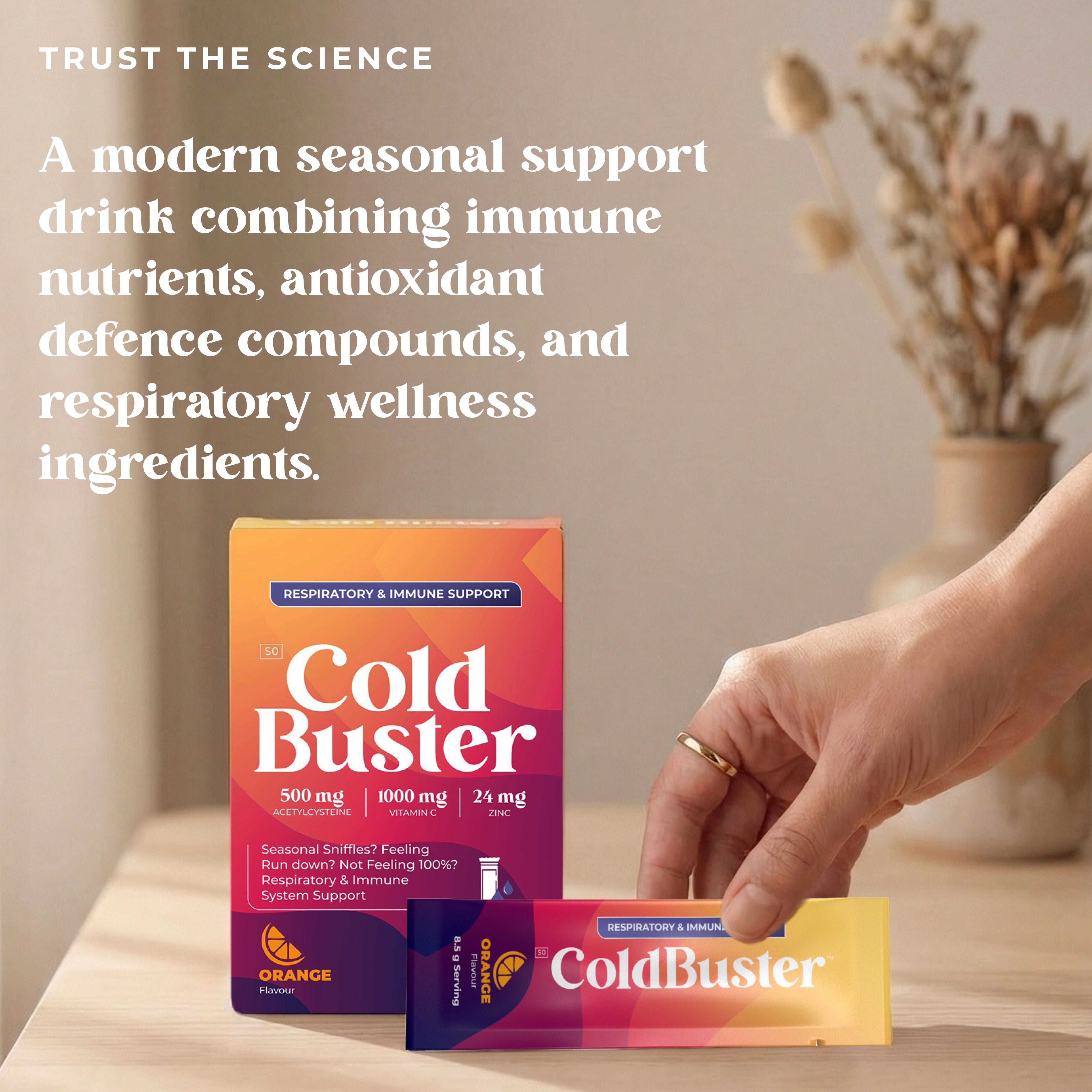 ColdBuster box and orange flavour sachets on a wooden surface, a seasonal support drink combining immune nutrients, antioxidant defence compounds, and respiratory wellness ingredients with 500mg Acetylcysteine, 1000mg Vitamin C, and 24mg Zinc.